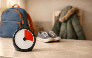 Visual timer for school morning routine with backpack, shoes, and coat prepared for children with autism