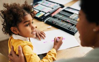 Child drawing during ABA therapy session with behavior analyst support at home in Maryland
