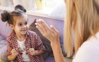 Child engaging in aba therapy home services session with therapist during play-based learning at home