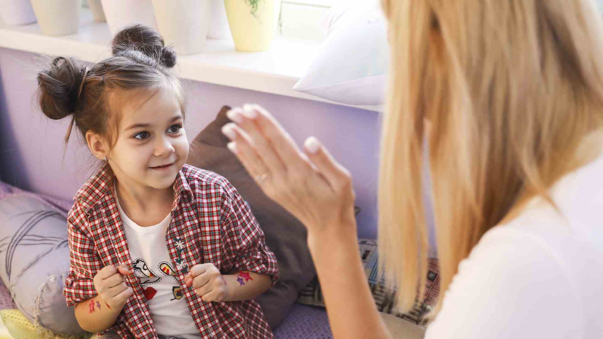 Child engaging in aba therapy home services session with therapist during play-based learning at home