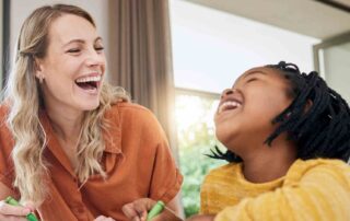 Child laughing with therapist during session at autism centers near me in a welcoming therapy environment