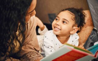 Parent reading with child showing benefits of aba therapy for children with autism in a supportive home environment