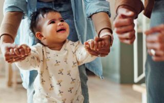 Toddler taking first steps with caregiver during early intervention services Maryland session at home
