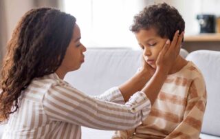 Parent helping child regulate emotions with calm support, demonstrating emotional regulation autism aba therapy techniques at home