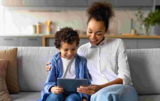 Mother and child using tablet together at home demonstrating balanced screen time for children with autism
