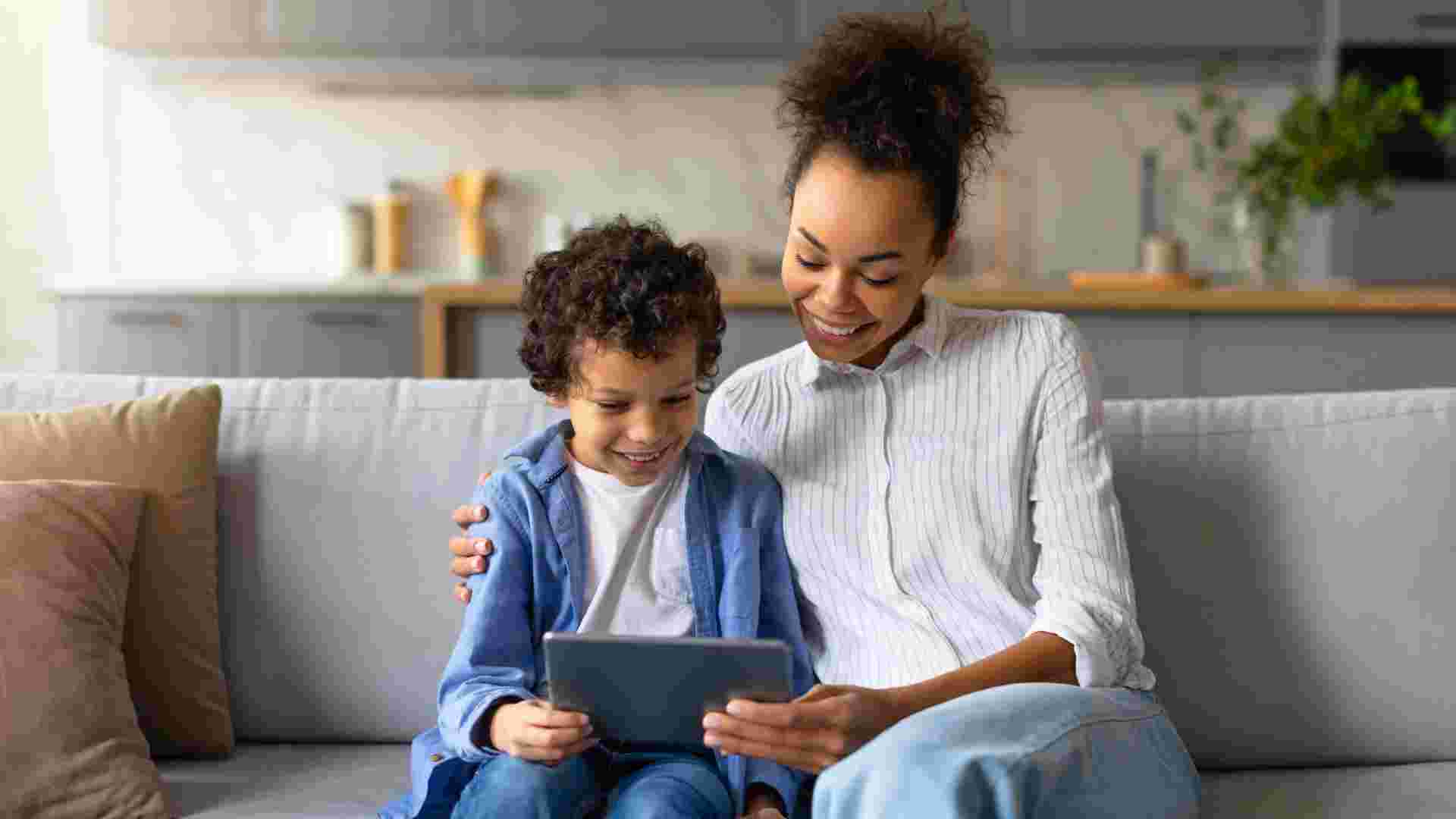 Mother and child using tablet together at home demonstrating balanced screen time for children with autism