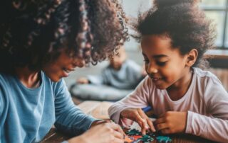 Child engaging in play-based ABA therapy activity with caregiver to build problem-solving and social skills in Maryland