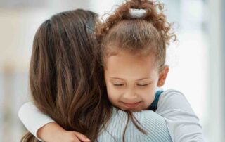 Parent comforting child to support emotional regulation in autism through ABA therapy at home in Maryland