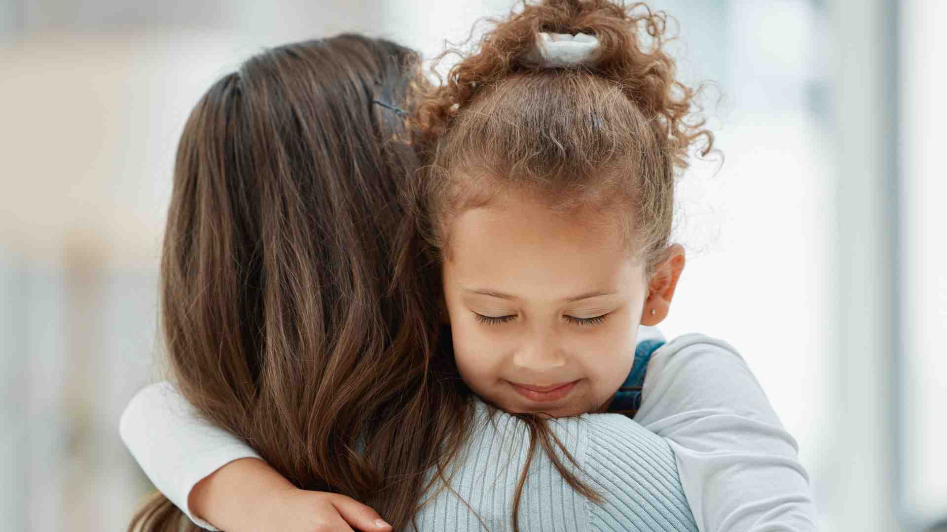 Parent comforting child to support emotional regulation in autism through ABA therapy at home in Maryland