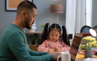 Parent helping child complete structured learning activity at home as part of an autism care plan using ABA therapy techniques