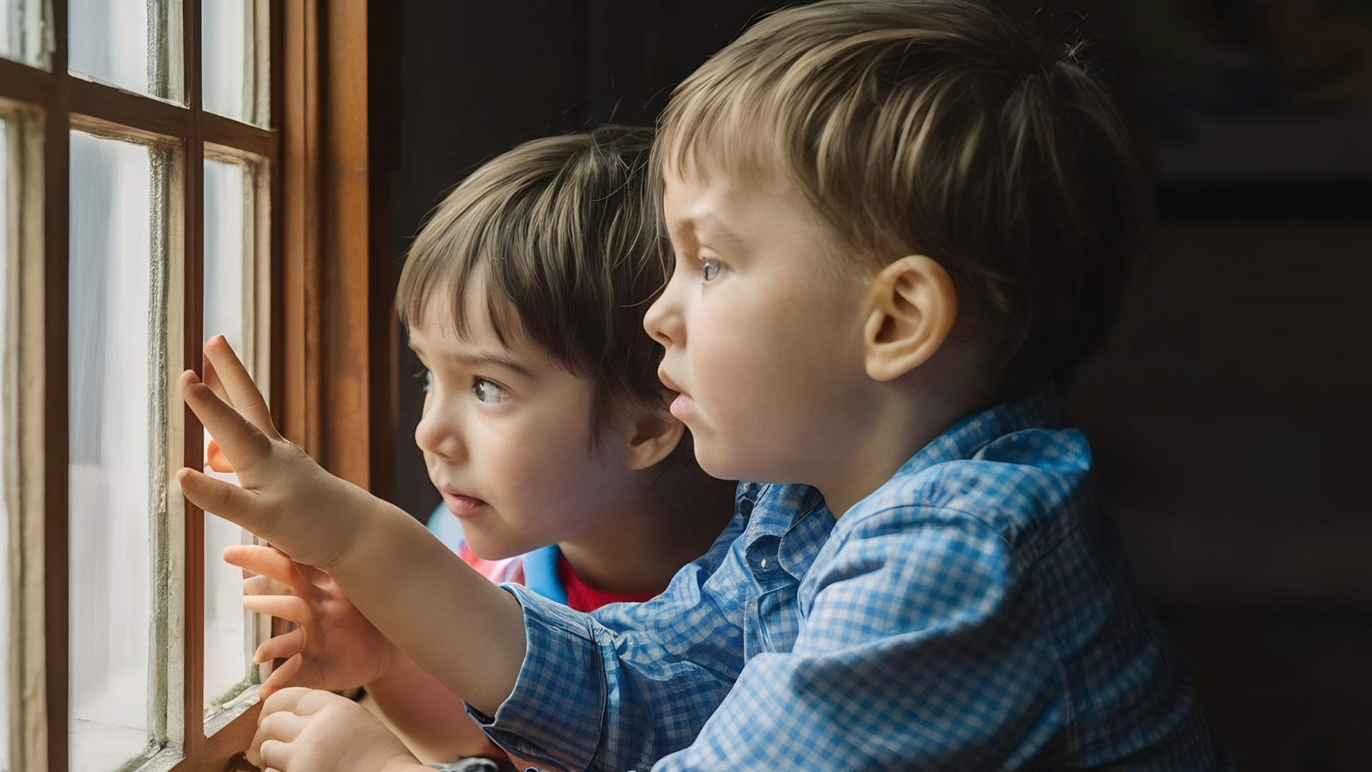Children looking out a window together showing curiosity and connection while learning how to understand autism, representing sibling support and guidance by The Learning Tree ABA