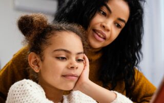 Mother and child reviewing behavior patterns together during a functional behavior assessment for autism support at home in Maryland