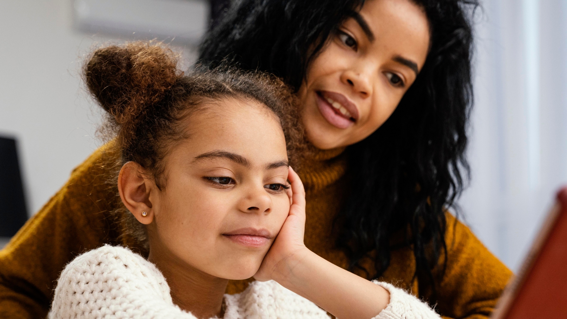 Mother and child reviewing behavior patterns together during a functional behavior assessment for autism support at home in Maryland