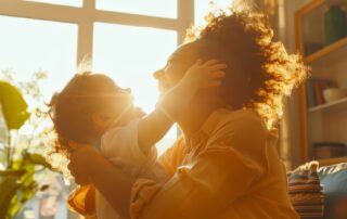 Mother and young child sharing a warm, loving moment at home, demonstrating positive parenting techniques for autism support in Maryland with The Learning Tree ABA